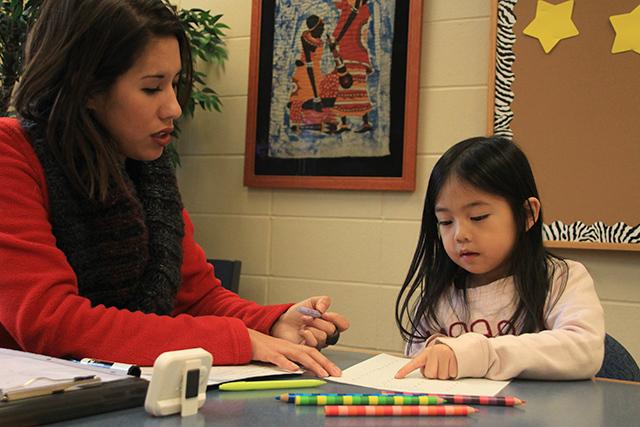 Jenny doing reading interventions with a little girl